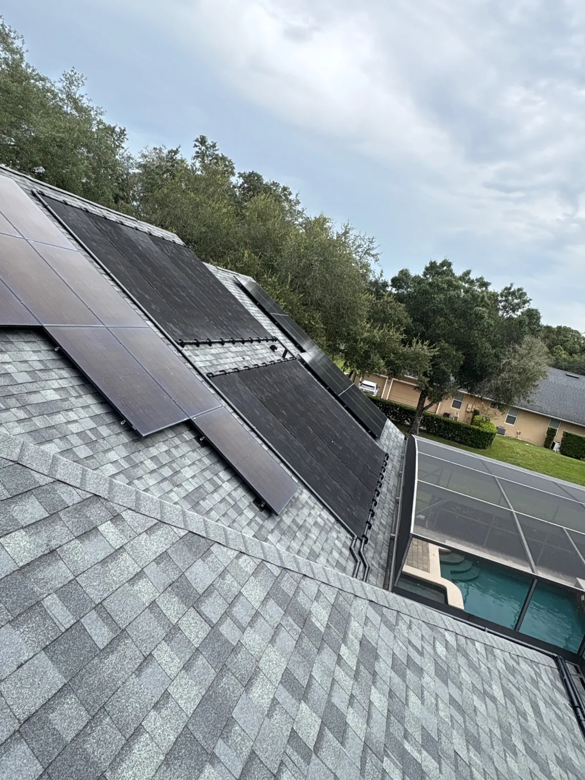 Solar pool heating collectors installed alongside photovoltaic solar panels.