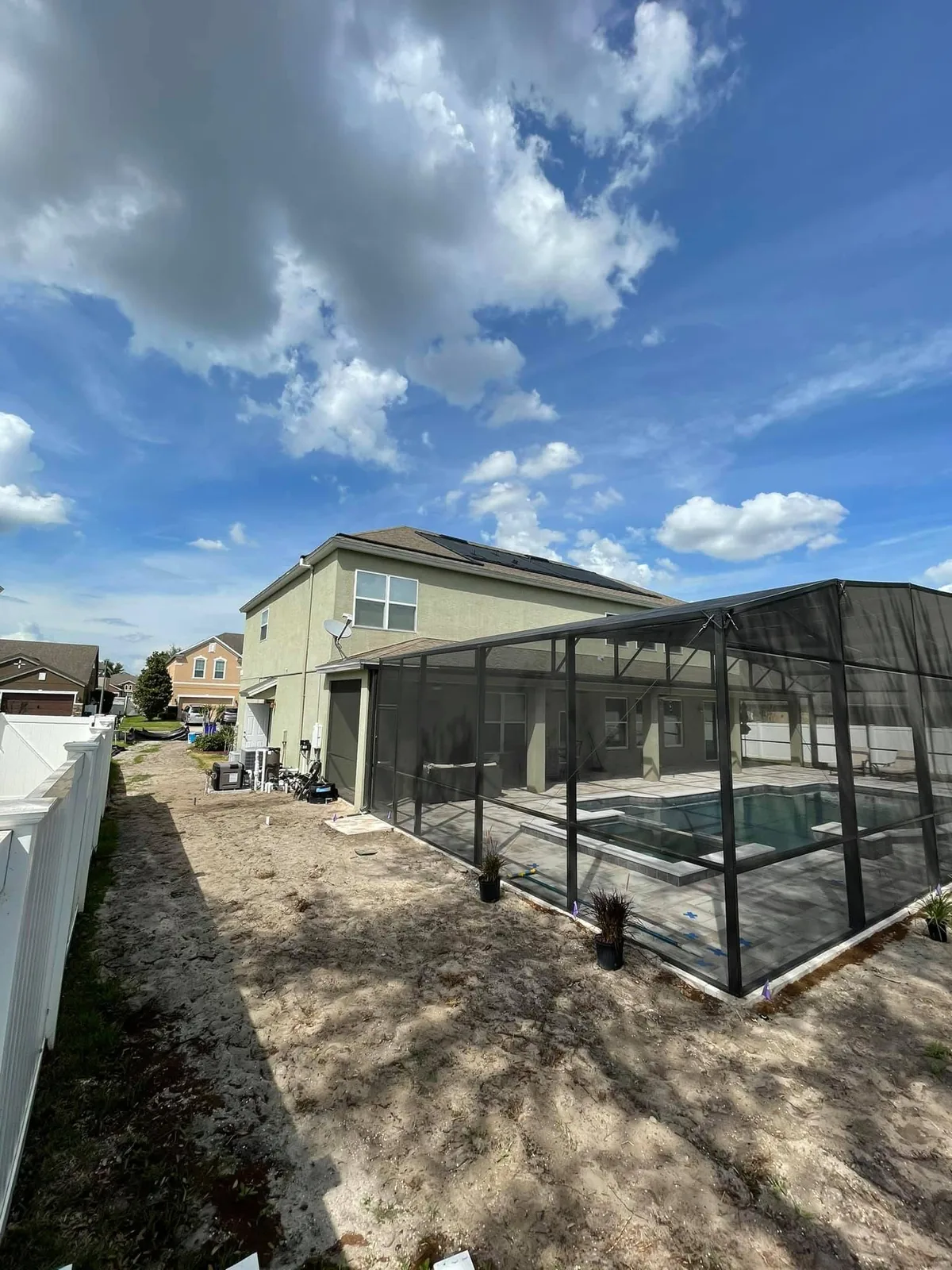 Residential pool home with solar pool heating equipment installed.