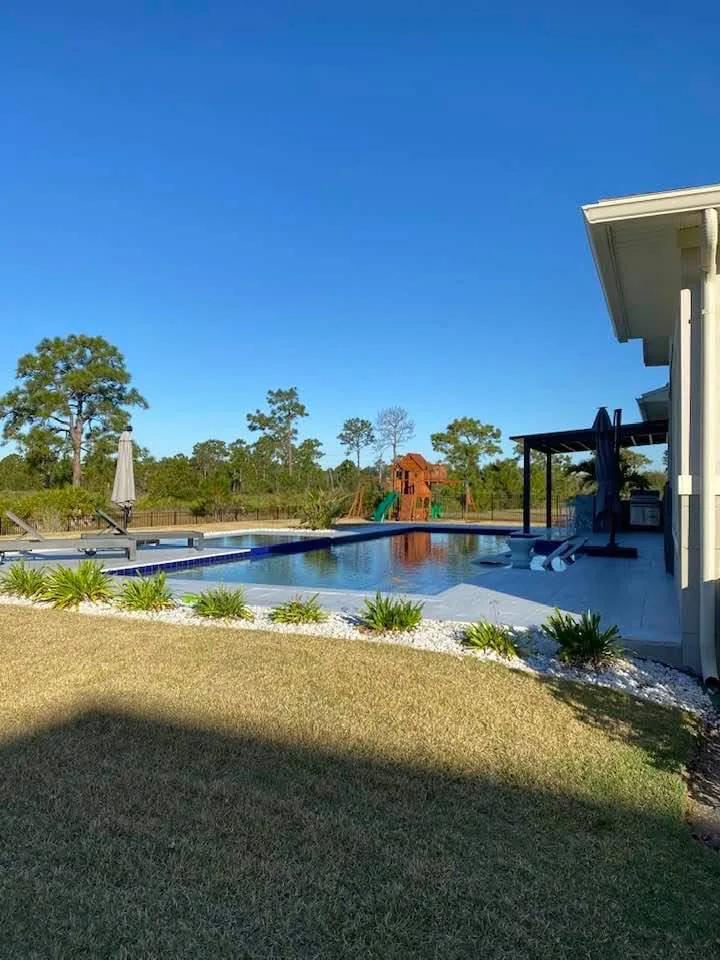 Backyard pool served by a solar pool heating system.